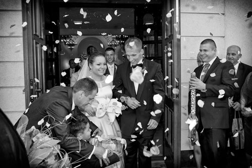 Wystrzał konfetii na wyjście pary młodej ceremonia ślubna w Warszawie, chłopiec podchodzi z gołąbkami.